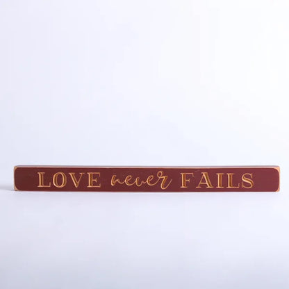 45cm Engraved Wooden Sign: Love Never Fails/Red - The Christian Gift Company