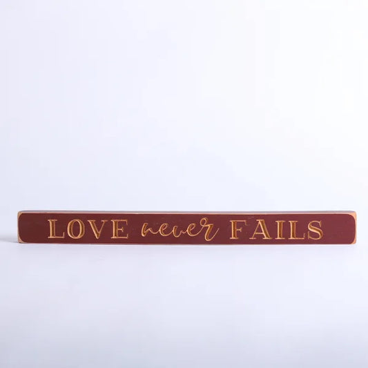 45cm Engraved Wooden Sign: Love Never Fails/Red - The Christian Gift Company
